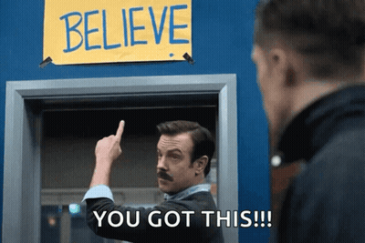 Man With Mustache Pointing At Believe Sign GIF