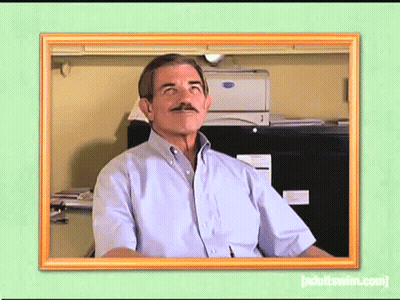 Man With Mustache Sitting At Desk In Front Of Printer GIF