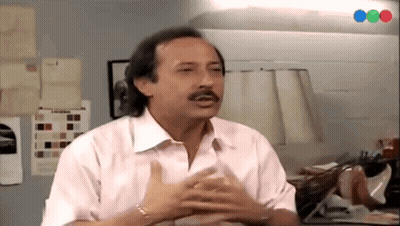 Man With Mustache Sitting At Table GIF