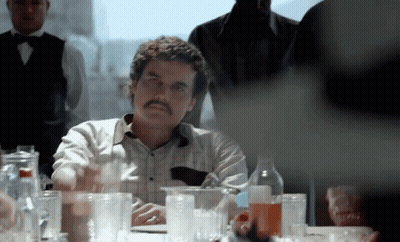 Man With Mustache Sitting At Table GIF