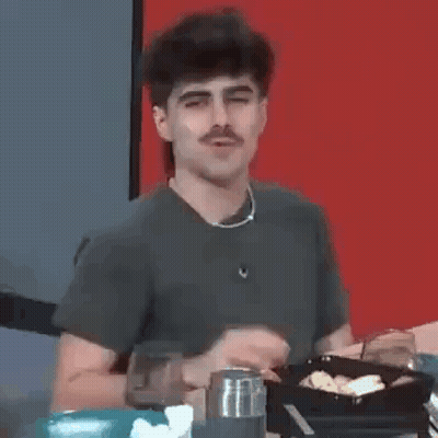 Man With Mustache Sitting At Table GIF