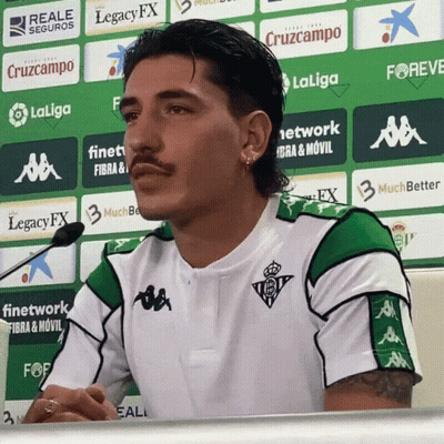 Man With Mustache Sitting In Front Of Legacy FX Sign GIF