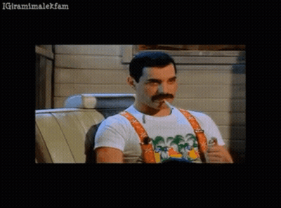 Man With Mustache Smoking Cigarette In Chair GIF