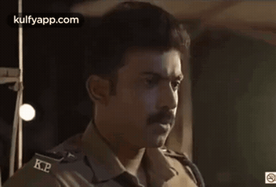 Man With Mustache Smoking Cigarette In Dark Room GIF
