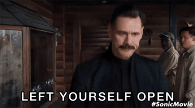 Man With Mustache Standing Before Group Saying Left Yourself Open GIF