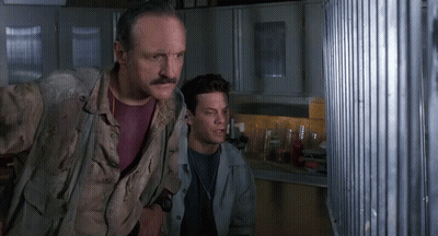 Man With Mustache Standing Next To Another Man In Kitchen GIF