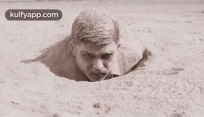 Man With Mustache Sticking Head Out Of Sand Hole GIF