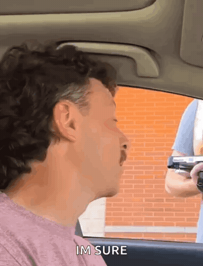 Man With Mustache Talking To Gun Holder GIF