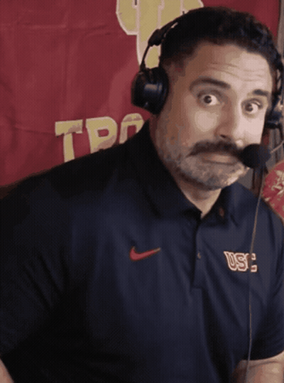 Man With Mustache Wearing Headphones And USC Shirt GIF