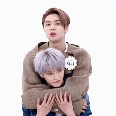 Man With NCT 127 Badge Hugging Another Man