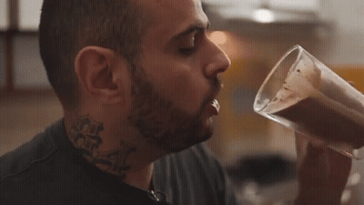 Man With Neck Tattoo Drinking From Cup GIF
