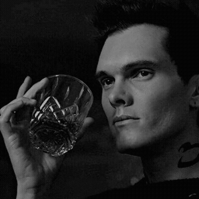 Man With Neck Tattoo Holding Glass Of Whiskey GIF