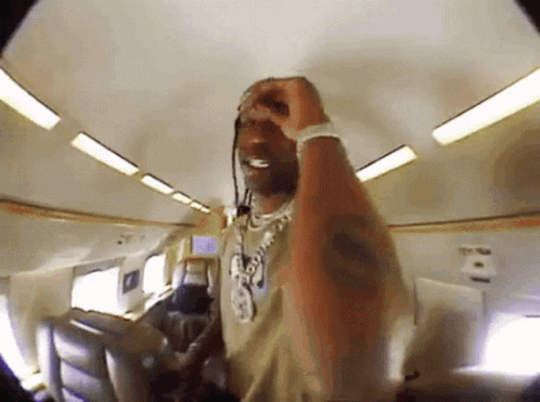 Man With Necklace And Bracelet On Plane GIF