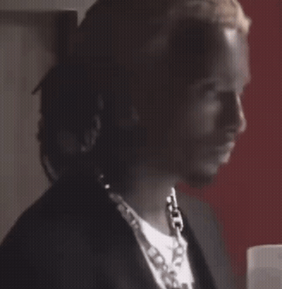Man With Necklace And Earrings At Door GIF