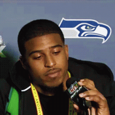 Man With NFL Lanyard Talking Into Microphone
