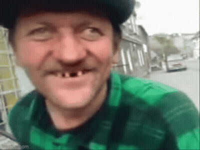 Man With No Teeth In Green Plaid Shirt And Hat Smiling GIF