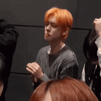 Man With Orange Hair Making Funny Face In Crowd GIF