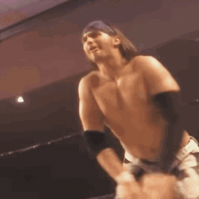 Man With Outstretched Hands By Brick Wall GIF