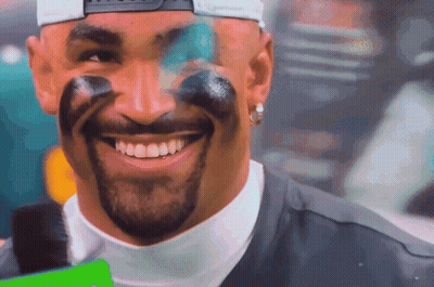 Man With Paint On Face Smiling In Baseball Cap GIF