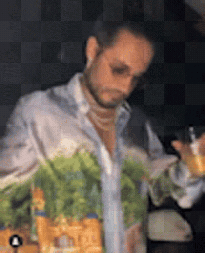 Man With Painted Shirt Holding Wine GIF