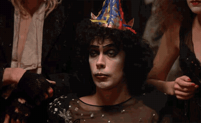 Man With Party Hat Sitting Hands Folded GIF