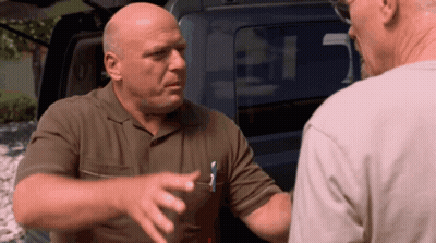 Man With Pen In Pocket Talks To Another Man In Front Of Car GIF