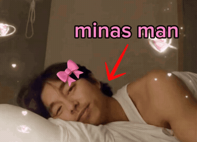 Man With Pink Bow Laying In Bed Saying Minas Man GIF
