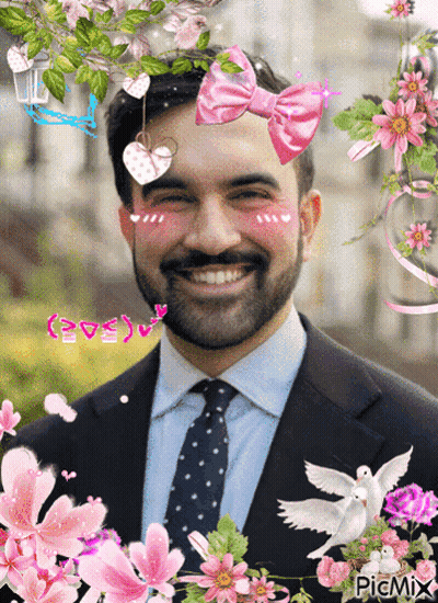 Man With Pink Bow Surrounded By Flowers GIF