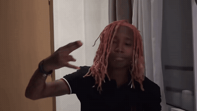 Man With Pink Dreadlocks In Black Shirt With Letter E GIF
