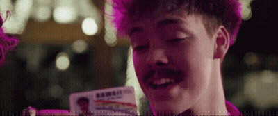 Man With Pink Hair And Mustache Holding ID Card Saying Hawaii GIF