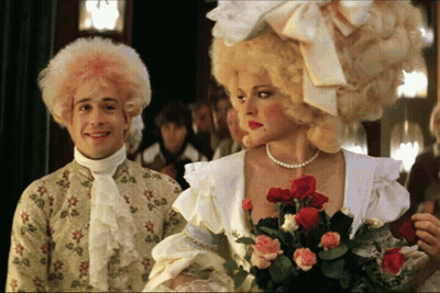 Man With Pink Hair And Woman With Red Roses GIF