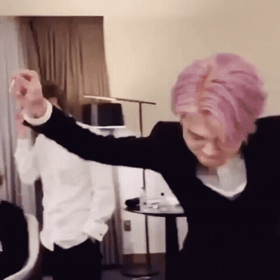 Man With Pink Hair Dancing While Another Man Watches GIF