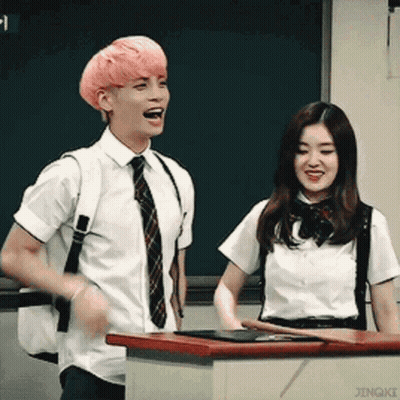 Man With Pink Hair Next To Woman In School Uniform GIF