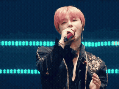 Man With Pink Hair Singing Into Microphone In Black Jacket And Choker GIF