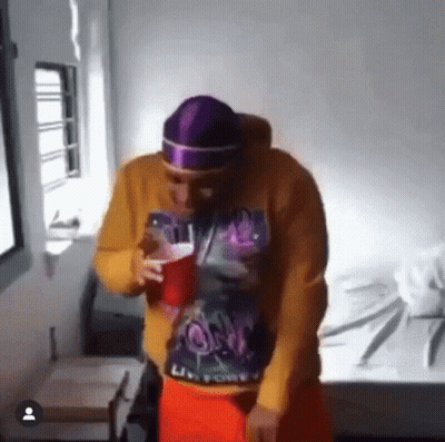 Man With Pink Scarf Around Head Holding Key GIF