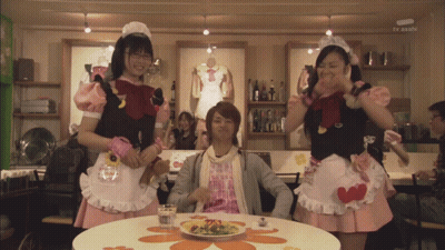 Man With Plate Of Food And Maids Behind GIF