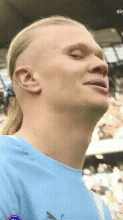 Man With Ponytail In Blue Sky Shirt GIF