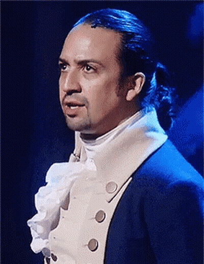 Man With Ponytail In Blue Suit And White Shirt GIF