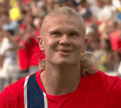 Man With Ponytail In Red And Blue Shirt GIF
