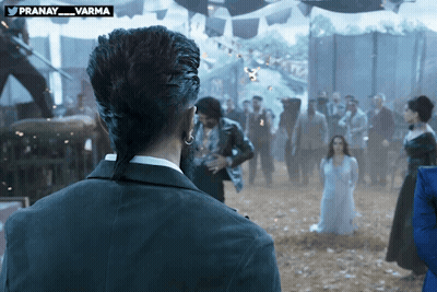 Man With Ponytail Standing In Front Of Crowd GIF