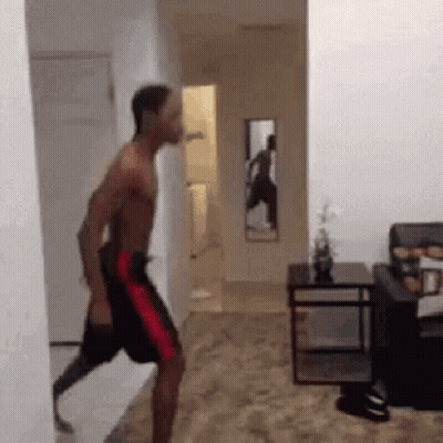 Man With Prosthetic Leg Walking Through Hallway GIF