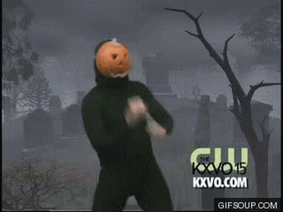 Man With Pumpkin On Head Dancing In Front Of Cemetery GIF