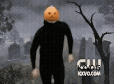 Man With Pumpkin On Head In Cemetery GIF