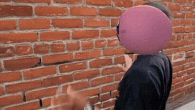 Man With Purple Balloon In Front Of Face GIF