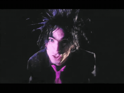 Man With Purple Hair And Tie In Dark GIF