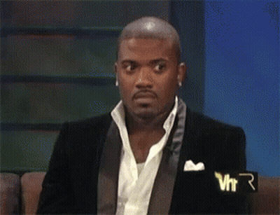 Man With Purple Hair And Yellow Hoodie Sitting GIF