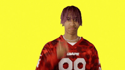 Man With Purple Hair Giving Peace Sign In Red BAPE Jersey GIF