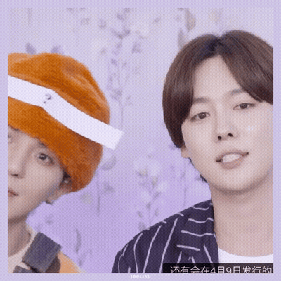 Man With Question Mark Headband Next To Another Man GIF