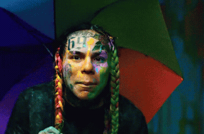 Man With Rainbow Umbrella On Head And Number 6 Face Tattoo GIF