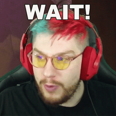 Man With Red And Green Hair In Headphones Saying Wait GIF